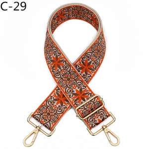 Close-up of retro floral woven bag strap C-29 with adjustable golden metal hardware
