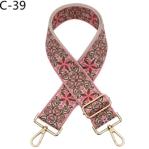 Detail of bohemian cream woven strap with pink floral embroidery and gold metal lobster clasps