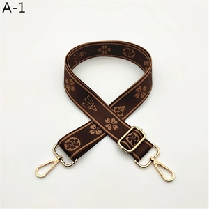 Detail of adjustable woven replacement strap with geometric floral patterns and gold clips