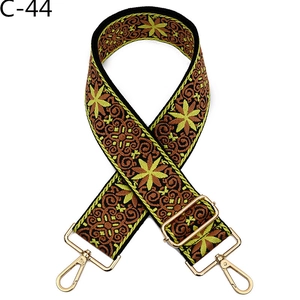 Detail of widening ethnic floral embroidery strap with golden metal swivel hooks