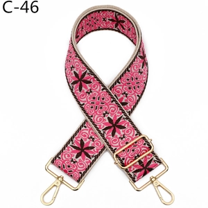 Detail of bohemian pink embroidery bag strap with gold metal swivel hook and buckle