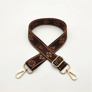 Adjustable brown woven shoulder strap with gold floral patterns for handbags