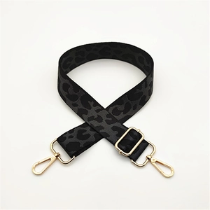 Detail view of leopard print jacquard shoulder strap with gold metal hardware and hooks