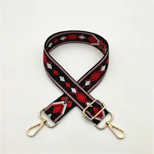 Close-up of woven geometric diamond shoulder strap with golden metal lobster clasps