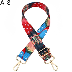 Detail of colorful geometric woven bag strap with golden metal swivel hooks and slider