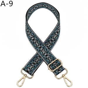 Close-up of ethnic geometric pattern strap with golden metal lobster clasps