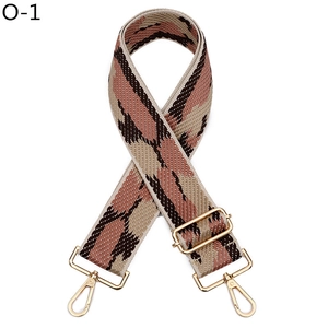 Macro detail of high-density jacquard bag strap with golden metal hardware and adjustable buckle