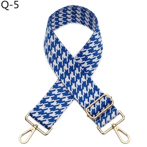 Close-up of blue and white houndstooth wide strap with premium gold metal clasps