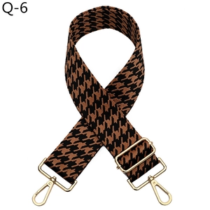 Adjustable brown and black houndstooth pattern bag strap with gold metal hooks