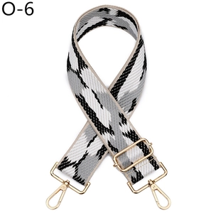 Macro detail of adjustable wide shoulder strap with black and white geometric weaving