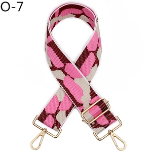 Detail of adjustable wide woven shoulder strap with pink snake pattern and gold hooks