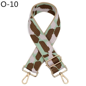 Detail of adjustable wide bag strap with leopard pattern and gold metal buckles