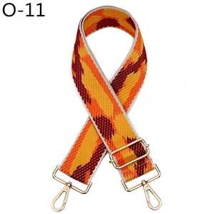 Detailed view of the woven geometric pattern strap with golden metal swivel snap hooks