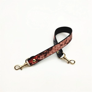 Reddish-brown python pattern PU leather bag strap with gold lobster clasps and rivets