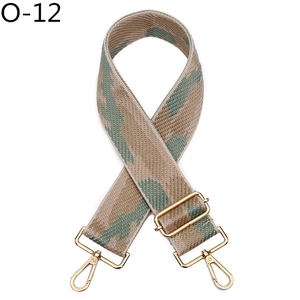 Close-up of wide camouflage jacquard bag strap with adjustable gold hardware buckles