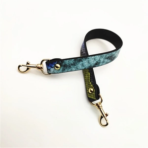 Detail of multi-color gradient PU bag strap with snakeskin texture and gold lobster clasps