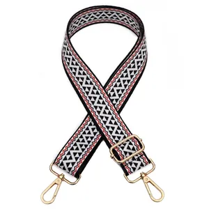 Detail view of woven bag strap No. 35 with black and white geometric pattern and gold clips