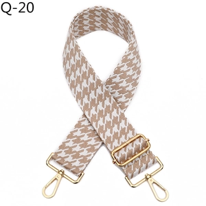Close-up of brown houndstooth woven strap with gold swivel lobster clasps for bags