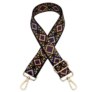 Detail of adjustable vintage geometric bag strap with golden metal hooks for handbags