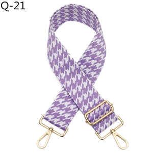 Detail of adjustable purple houndstooth strap with polished gold metal hardware
