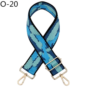 Close-up of bohemian blue geometric woven strap with gold metal lobster clasps
