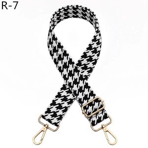Detail of adjustable houndstooth shoulder strap with high-quality gold metal lobster clasps