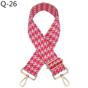 Close-up of pink houndstooth woven handbag strap with premium gold metal hardware