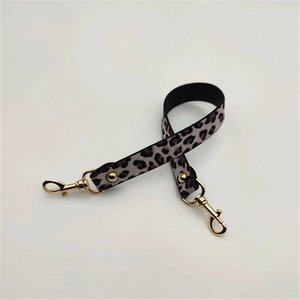 Close-up of leopard print PU leather handbag strap with polished gold lobster clasps