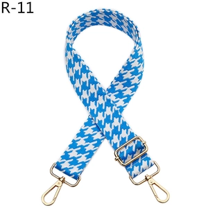 Detail of adjustable blue and white houndstooth strap with golden metal lobster clasps