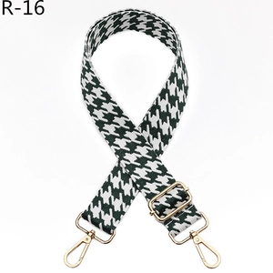 Detail of green houndstooth jacquard shoulder strap with gold metal lobster clasps