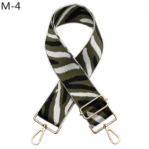 Detail of adjustable horse-stripe woven bag strap with premium gold metal hardware hooks