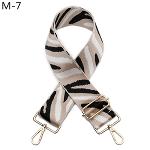 Close-up of zebra pattern wide replacement bag strap with golden metal lobster clasps