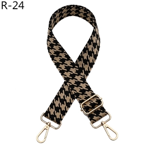 Detail of houndstooth jacquard bag strap with gold lobster clasps and metal adjustment buckle