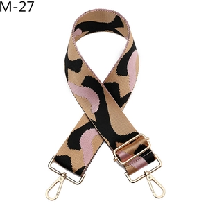 Close-up of pink and brown patterned wide adjustable shoulder strap with gold lobster clasps