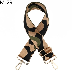 Close-up of adjustable camo shoulder strap with premium golden metal lobster hooks