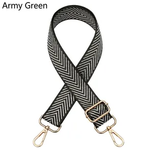 Detail of army green nylon woven bag strap with golden metal swivel hooks and buckles