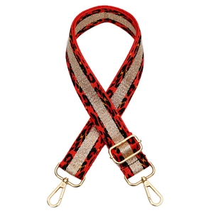 Detail of red leopard print bag strap with golden metallic weave and lobster clasps