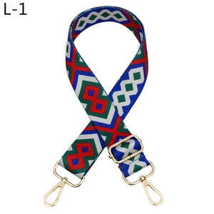 Detail of colorful geometric bohemian wide shoulder strap with gold metal lobster hooks