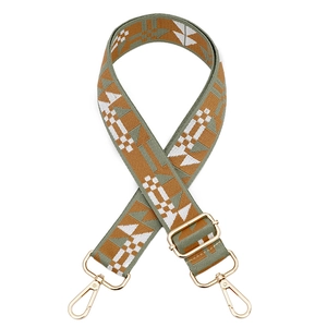 Detail showing jacquard canvas bag strap with geometric ethnic pattern and gold metal hooks
