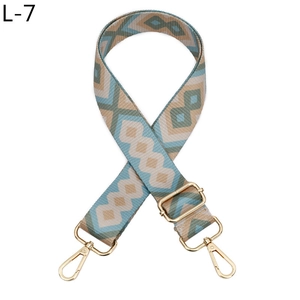Detail of adjustable geometric diamond pattern bag strap with gold metal lobster hooks