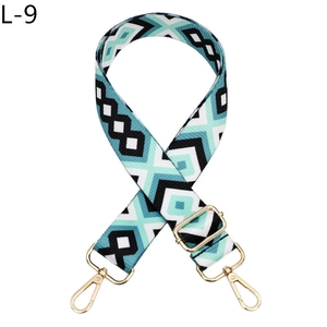 Detail of adjustable geometric jacquard bag strap with gold metal lobster clasps