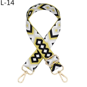 Detail of colorful geometric ethnic style woven bag strap with golden metal hook