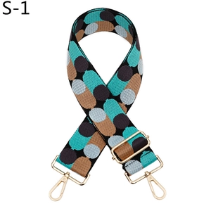 Macro detail of adjustable jacquard bag strap with geometric dots and gold hardware