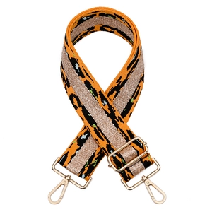 Detail of adjustable leopard print bag strap with golden metallic hardware