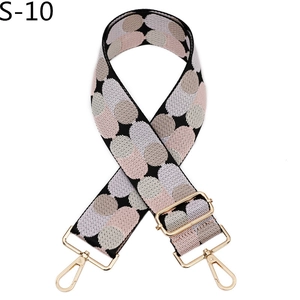 Close-up of colorful polka dot pattern shoulder strap with golden metal swivel hooks