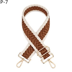Détail de la bandoulière réglable à chevrons marron et blanc avec mousquetons dorés
