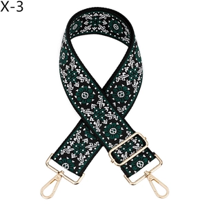 Detail of ethnic floral jacquard strap with gold-tone metal lobster clasps and buckle