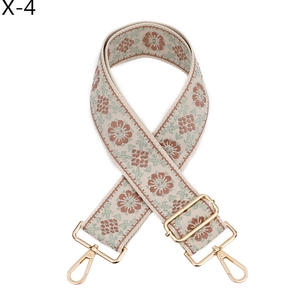 Detail of bohemian jacquard bag strap with floral embroidery and golden metal lobster clasps