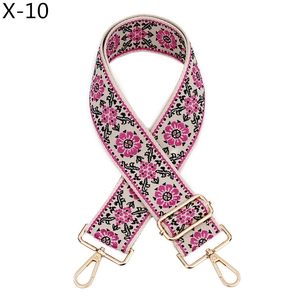 Detail of bohemian floral embroidery strap with golden metal lobster clasps for bags