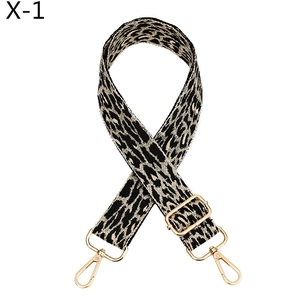 Close-up of leopard print bag strap with thick weave and golden metal spring hooks